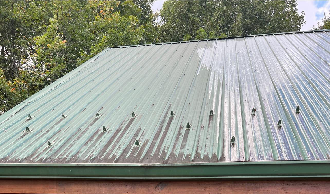 A metal roof oxidised to a chalky white grey before the wash